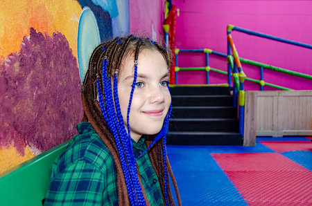 Cute young girl enjoy playing in indoor playground.Concept photo of child, childhood and girls...