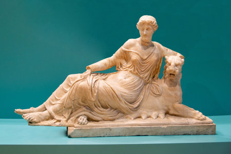 Museum photography. Ancient roman marble statue. Young person figure statue isolated on colored...