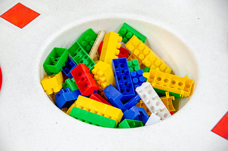 Colorful rainbow plastic toy bricks blocks isolated on white. Education concept. Blue, red and...