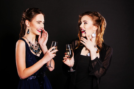 Two beautiful women in  black cocktail dressesの写真素材