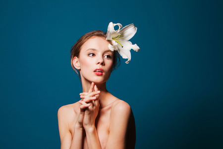 teenage girl with white flower on  blueの写真素材