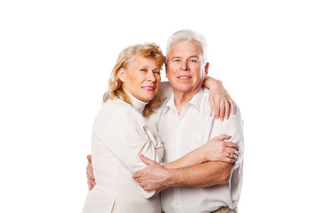 Happy mature couple smiling at camera on white backgroundの写真素材