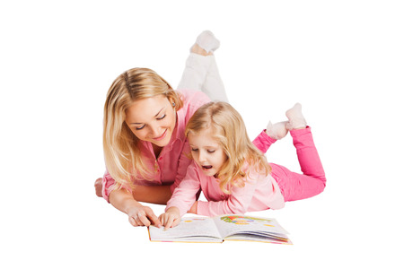 Young smiling mother with little daughter studyingの写真素材