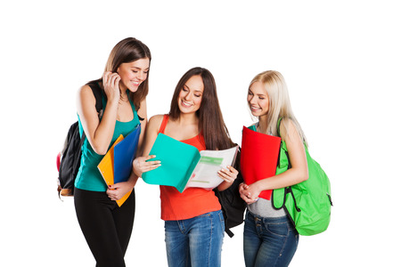 Happy students standing together with fun, while smiling and looking at camera isolated on white background.の写真素材