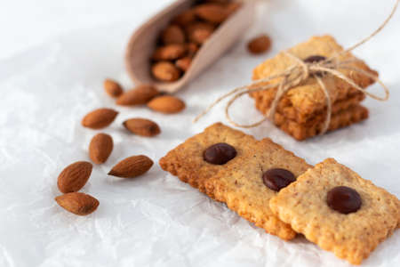 Cookies with almonds and chocolate with almond seeds on a light background. Beautiful homemade...