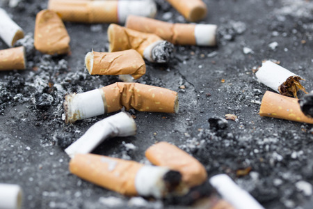 Cigarette butts, anti-smoking lawの写真素材