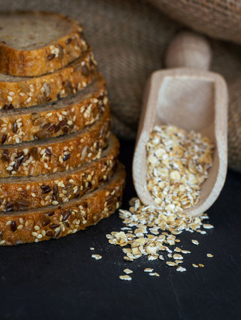Bread selection with oats in a wodden spoon. Food styling