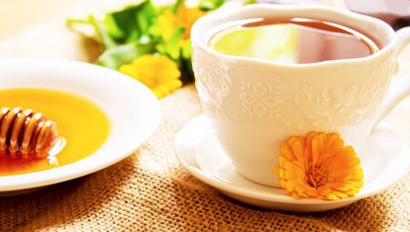 honey with dandelions. cup of tea with dandelion. selective focus.natureの写真素材