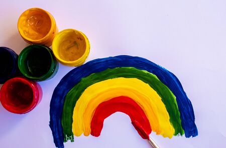 Painting a rainbow during quarantine Covid-19 at home. Stay at home. Selective focus.の写真素材