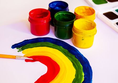 Painting a rainbow during quarantine Covid-19 at home. Stay at home. Selective focus.の写真素材