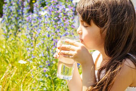 child glass of water. selective focus. Children natureの写真素材