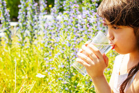 child glass of water. selective focus. Children natureの写真素材
