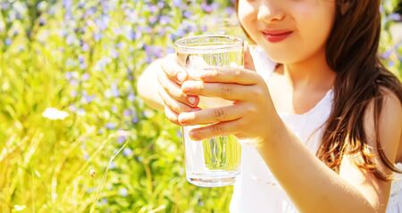 child glass of water. selective focus. Children natureの写真素材