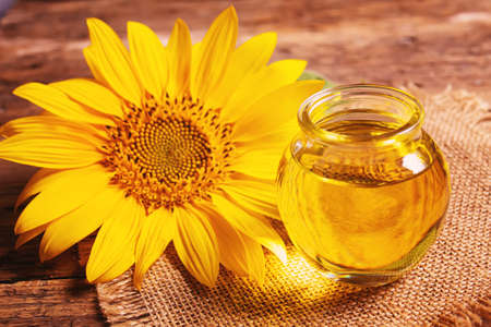 Sunflower seeds and oil bottle on old wooden background. Selective focus.natureの写真素材