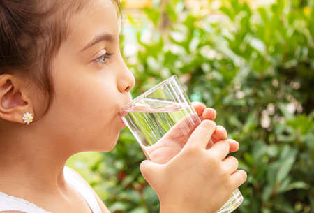 Child drinking pure water in nature.selectiv fokus.natureの写真素材