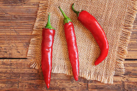 hot chili peppers on wooden background. selective focusの写真素材