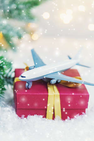 Travel for Christmas. Airplane with Christmas decor. Selective focus.の写真素材