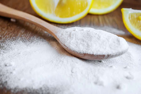 Citric acid on a wooden background with lemon. Selective focus.foodの写真素材