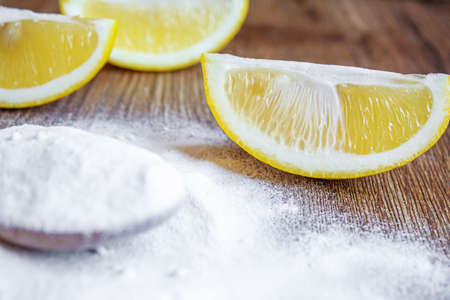 Citric acid on a wooden background with lemon. Selective focus.foodの写真素材
