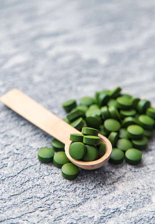 Green pills of chlorella and spirulina. Selective focus drinkの写真素材