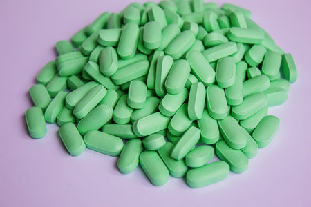 Vitamin tablets used as a dietary supplement.green tablets..selective focus.medical