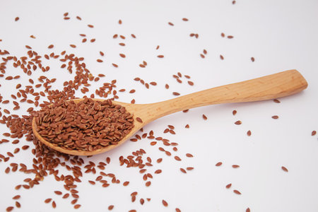 Flax seeds on a white background close-up of flax seeds in a wooden spoon. selective focus.foodの写真素材