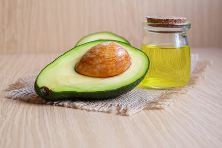 Avocado and avocado oil on wooden background. Selective focus.food