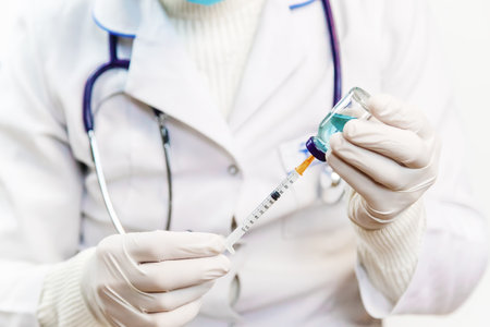 Doctor filling syringe with medication, closeup. Vaccination and immunization. Selective focus. Vaccine.の写真素材