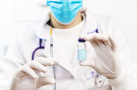Doctor filling syringe with medication, closeup. Vaccination and immunization. Selective focus. Vaccine.の写真素材