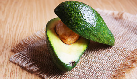Avocado and avocado oil on wooden background. Selective focus.food