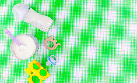 Baby accessories and food on a green background. Selective focus.baby