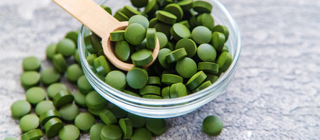 Green pills of chlorella and spirulina. Selective focus drinkの写真素材