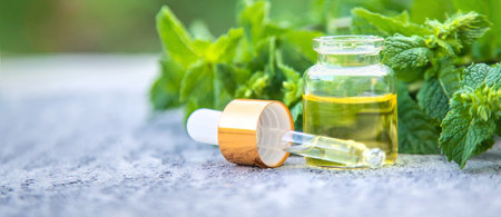Peppermint essential oil in a small bottle. Selective focus. nature.の写真素材