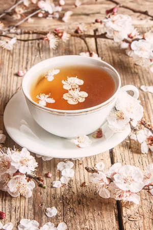 Cup of tea and spring flowers on a wooden background. Selective focus.natureの写真素材