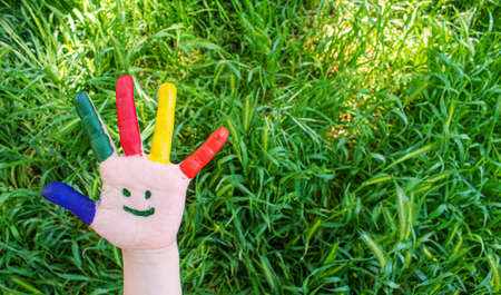 Children's hands in the colors of summer. Selective focus.nature