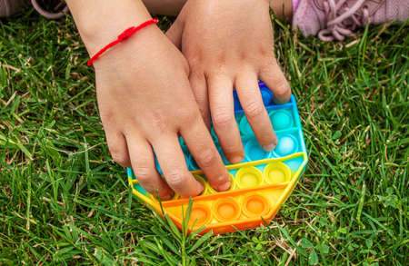 The child plays anti-stress pop it .Selective focus.peopleの写真素材