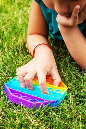 The child plays anti-stress pop it .Selective focus.peopleの写真素材