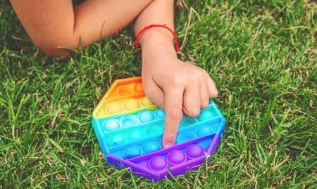 The child plays anti-stress pop it .Selective focus.peopleの写真素材