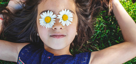 girl is holding chamomile flowers in her hands. Selective focus. nature.の写真素材