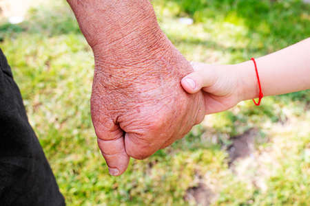 old man holding child's hands. selective focus peopleの写真素材