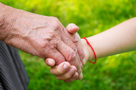 old man holding child's hands. selective focus peopleの写真素材