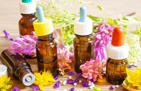 medicinal herbs, oils in small bottles homeopathy. selective focus.の写真素材