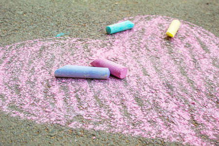 child painted a heart on the asphalt with chalk. selective focus.artの写真素材