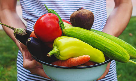 A man in the garden with vegetables in his hands. Selective focus. nature.の写真素材