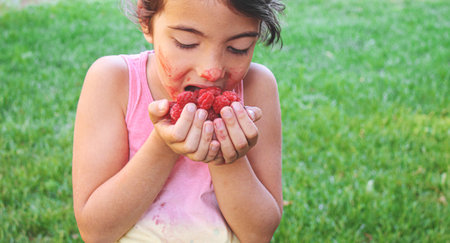 baby eats raspberries .selective focus.foodの写真素材