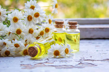 Medicinal herbs in bottles. chamomile oil extract. Selective focus. Nature.の写真素材