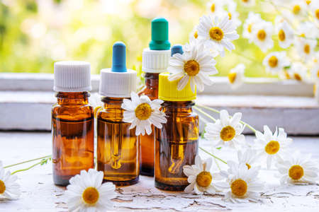 Medicinal herbs in bottles. chamomile oil extract. Selective focus. Nature.の写真素材