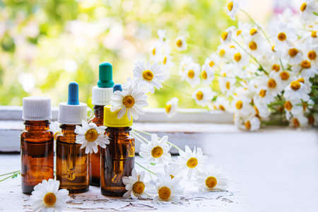 Medicinal herbs in bottles. chamomile oil extract. Selective focus. Nature.の写真素材