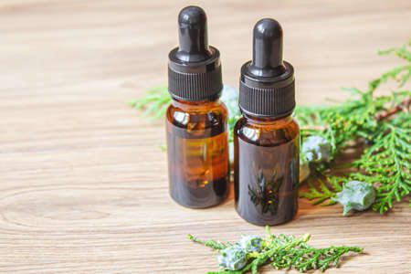 Juniper essential oil in a small bottle. Selective focus. nature.の写真素材