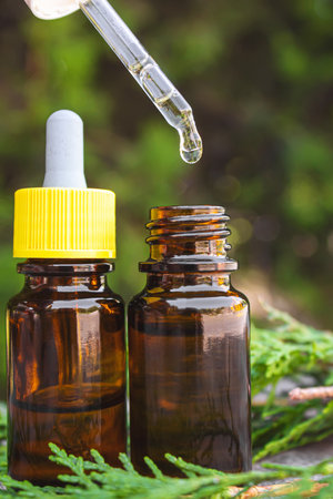 Juniper essential oil in a small bottle. Selective focus. nature.の写真素材